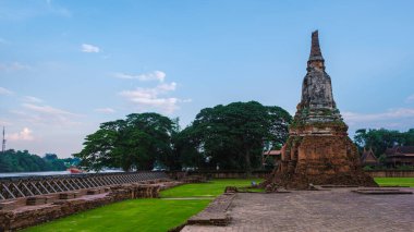 High water at the river in Ayutthaya, Thailand at Wat Chaiwatthanaram during sunset in Ayutthaya Thailand during the monsoon rain season,high water protection wall by river