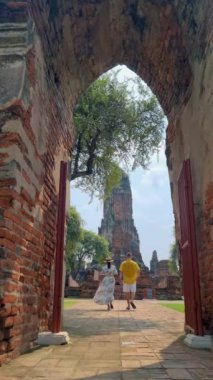 Ayutthaya, Thailand at Wat Phra Ram, a couple of men and women with a hat visiting Ayyuthaya Thailand. Tourist with map in Thailand