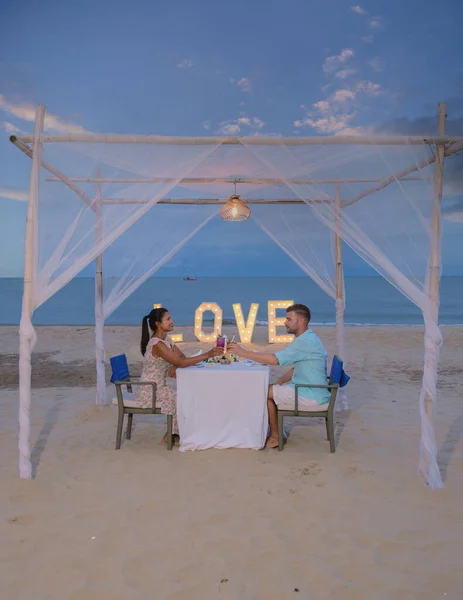 Romantic dinner on the beach of Huahin Thailand, dinner by candlelight in Hua Hin, Valentines concept. Couple of men and women having a romantic dinner on the beach in Thailand