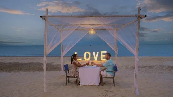 Romantic dinner on the beach of Huahin Thailand, dinner by candlelight in Hua Hin, Valentines concept. Couple of men and women having a romantic dinner on the beach in Thailand
