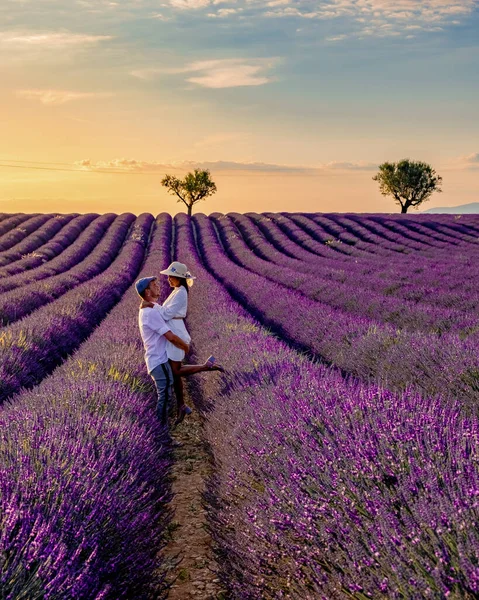 Couple men and women watching the sunset in a Lavender field, Provence, Lavender field France, Valensole Plateau, a colorful field of Lavender Valensole Plateau, Couple men and woman at the Provence