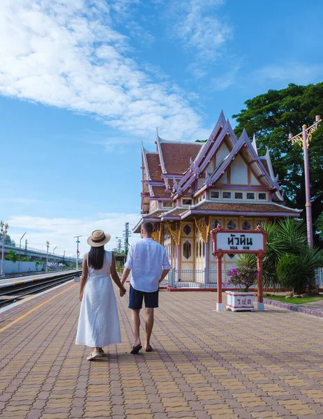 2人の男女がタイのホアヒン駅を歩いている アジア系の女性と白人男性がハイン駅を歩いている — ストック写真