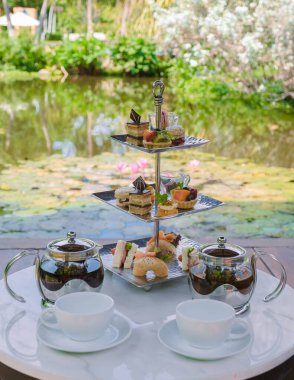 Bir su birikintisinde ikindi çayı, Tayland 'da tropikal bir bahçede çay.. 
