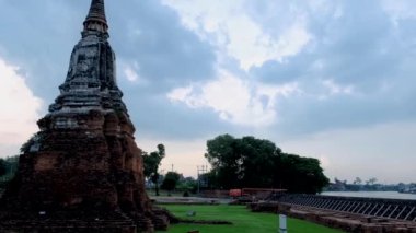 High water at the river in Ayutthaya, Thailand at Wat Chaiwatthanaram during sunset in Ayutthaya Thailand during the monsoon rain season,high water protection wall by river