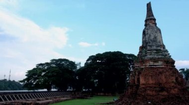 High water at the river in Ayutthaya, Thailand at Wat Chaiwatthanaram during sunset in Ayutthaya Thailand during the monsoon rain season,high water protection wall by river
