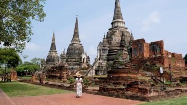 Ayutthaya, Thailand at Wat Phra Si Sanphet, a couple of men and women with a hat visiting Ayyuthaya Thailand. Tourist with map in Thailand