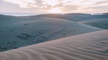 Güneş doğarken Maspalomas Gran Canaria 'nın kum tepeleri. Gran Canaria çölünde güzel kum tepecikleri