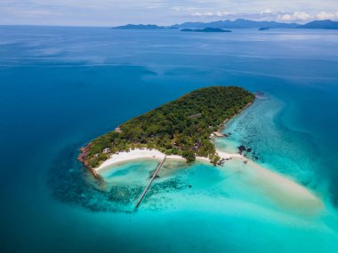 Tropik ada Koh Kham Trat Tayland, Koh Mak Tayland yakınlarındaki tropik adanın havadan görünüşü. Beyaz kumlu sahil, palmiye ağaçları ve okyanusta büyük siyah kaya taşları.