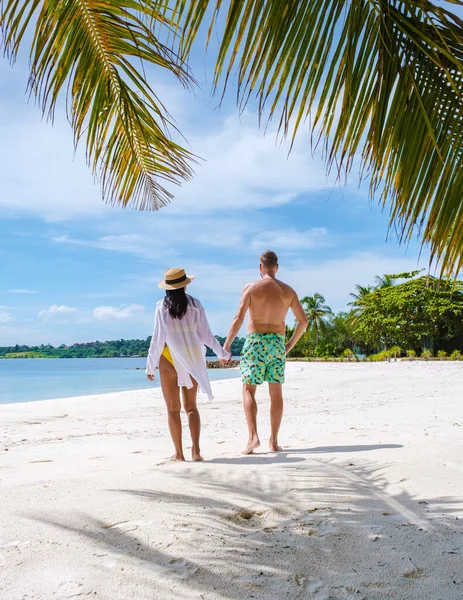 タイの白い熱帯のビーチ Koh Kham Tratを歩いてショートパンツを泳ぐ男性と女性 ヤシの木と白い砂でビーチでアジア系の女性を泳がせ — ストック写真