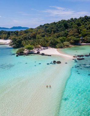 Tayland 'da tropikal bir plajda Koh Kham Tayland Trat. Tropik bir adada Asyalı kadınlar ve beyaz erkekler