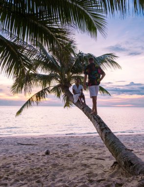 Tropikal bir plajda gün batımını izleyen çift, Koh Kood veya Koh Kut Tayland. 