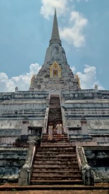Wat Phu Khao Thong chedi in Ayutthaya, Thailand. White pagoda, couple men and women on a trip to Ayutthaya visit the white pagoda temple