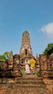 Ayutthaya, Thailand at Wat Ratchaburana, a couple of men and women with a hat visiting Ayyuthaya Thailand. Tourist with map in Thailand