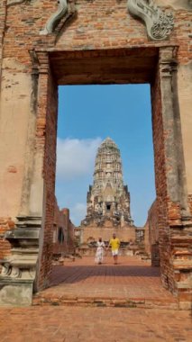 Ayutthaya, Thailand at Wat Ratchaburana, a couple of men and women with a hat visiting Ayyuthaya Thailand. Tourist with map in Thailand