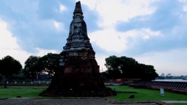 High water at the river in Ayutthaya, Thailand at Wat Chaiwatthanaram during sunset in Ayutthaya Thailand during the monsoon rain season,high water protection wall by river