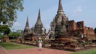 Ayutthaya, Thailand at Wat Phra Si Sanphet, women with a hat and tourist map visiting Ayyuthaya Thailand. Tourist with map in Thailand