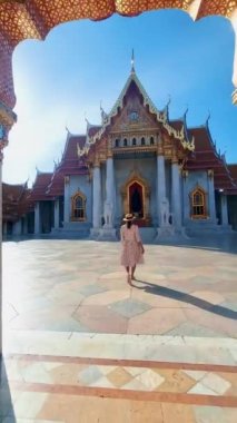 Wat Benchamabophit temple in Bangkok Thailand, The Marble temple in Bangkok Thailand, couple men and women visiting the Marble temple in Bangkok