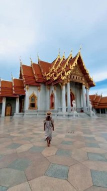 Wat Benchamabophit temple in Bangkok Thailand, The Marble temple in Bangkok Thailand, couple men and women visiting the Marble temple in Bangkok