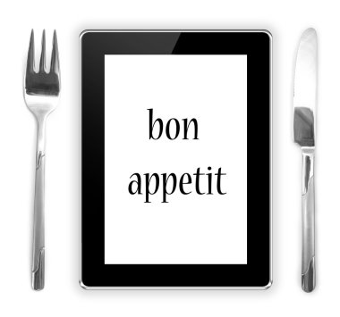 çatal bıçakla tablet bilgisayarın yakınında. yenilebilir tablet yüklü