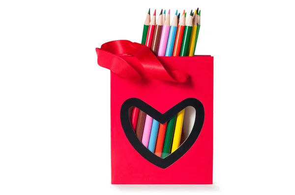 Lápis coloridos em um saco vermelho — Fotografia de Stock