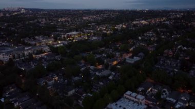 Fly over houses in a residential neighbourhood in Vancouver at twilight