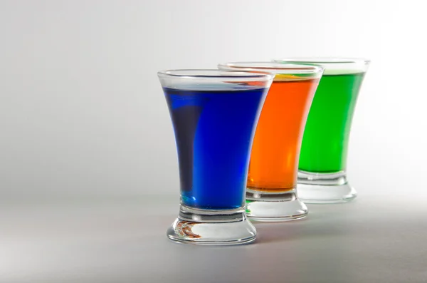 Three multi-colored shot glasses — Stock Photo, Image