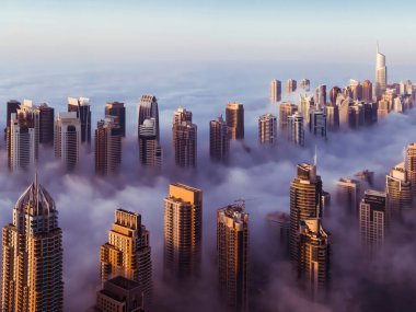Dubai Marina skyscrapers covered with fog clipart
