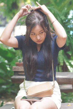 Portrait of beautiful asian girl applying and hair set by herself