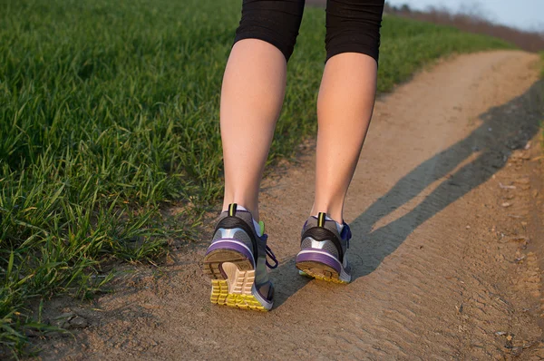 Runner feet running on road closeup on shoe. woman fitness — Stock Photo, Image