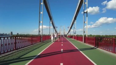 Kyiv, Ukraine - July 24, 2022: People are walking on the pedestrian bridge in Kyiv, Ukraine
