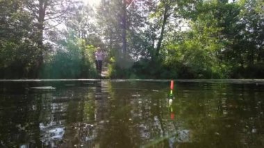 A woman observes a float in the water.