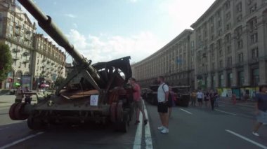 Kyiv, Ukraine - August 24, 2022: Evidence of Russian military aggression against Ukraine - burned and destroyed Russian military equipment on Kreshchatik in Kiev. People look at and take pictures of Russian equipment destroyed in Ukraine.