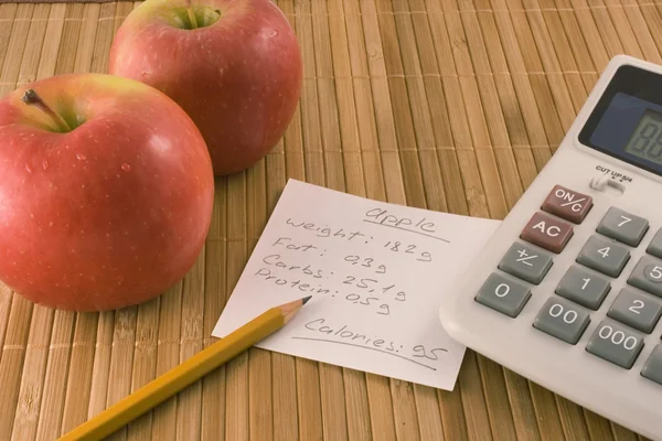 Beslenme bilgileri, bir elma ve bir hesap makinesi — Stok fotoğraf