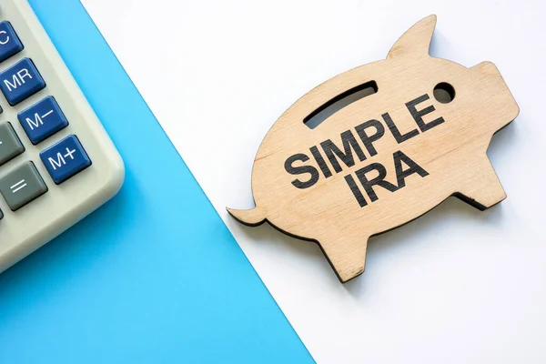 Wooden piggy bank with words SIMPLE IRA plans savings incentive match plans for employees. — Stock Photo, Image