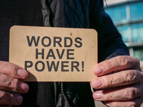 Man holds plate with sign Words have power. — Stock fotografie