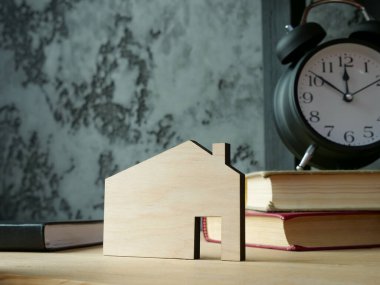 Emlak yatırımının sembolü olarak raftaki ev modeli.