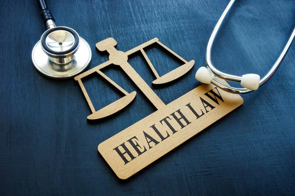 A plate in the form of scales with an sign Health law. — Stock Photo, Image