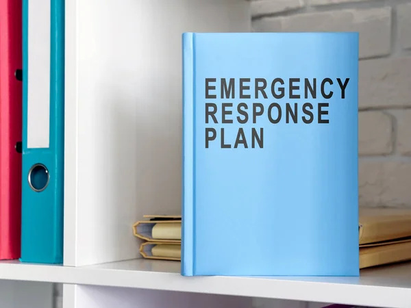 Blue book emergency response plan on the shelf.