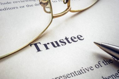 Word trustee near glasses and a pen. clipart