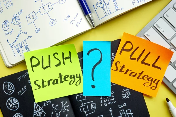 Push or pull strategy in marketing. Notepads and keyboard. — ストック写真