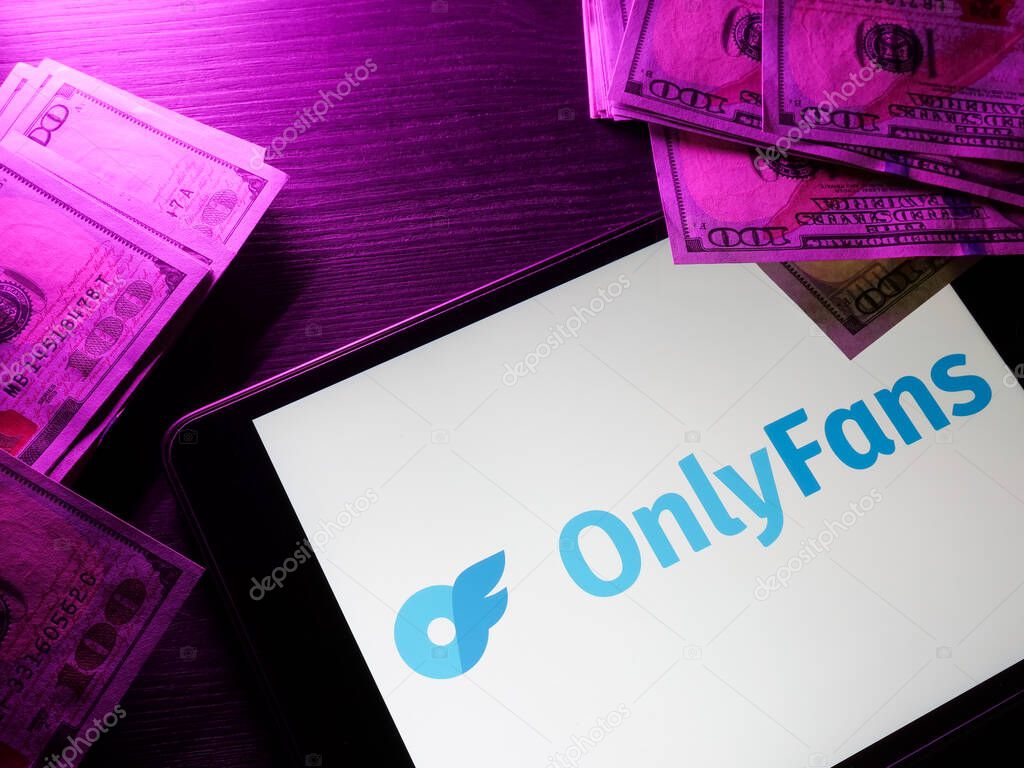 KYIV, UKRAINE - May 4, 2022. Tablet with onlyfans logo and money. Editorial.