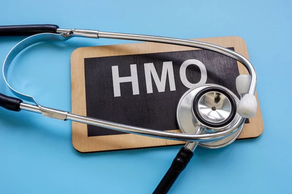 A Plate with an inscription Health Maintenance Organization HMO and a stethoscope.
