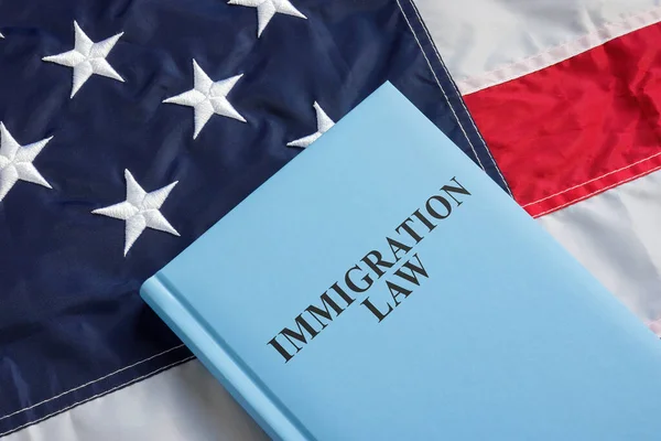 The immigration law book is on the US flag.