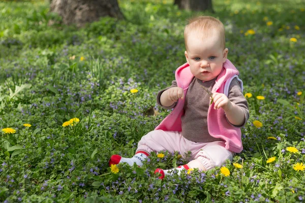 Piccolo bambino che gioca nel parco sull'erba in una giornata di sole — Foto Stock