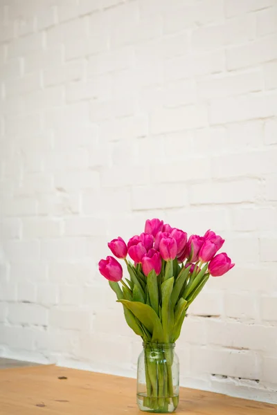 Beautiful pink tulips in a vase — Stock Photo, Image