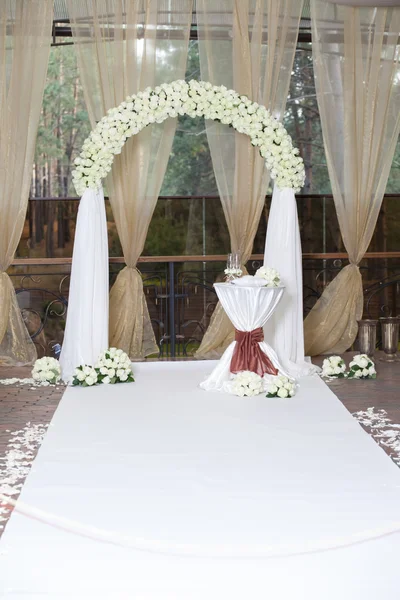 Hermoso arco de bodas con rosas en el restaurante — Foto de Stock