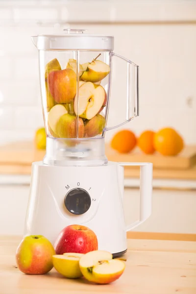 White blender with apples on a wooden table. — Stock Photo, Image