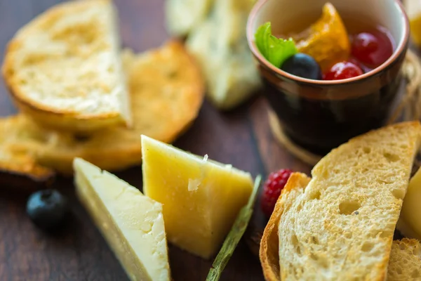 Assorted cheese on a wooden board. — Stock Photo, Image