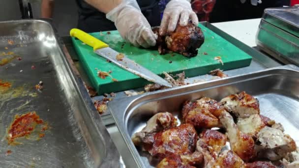 Szef kuchni kroi grillowanego kurczaka, kroi chiken zbliżenie, siekanie grillowanego kurczaka zwolniony ruch, Cięcie pieczonego kurczaka — Wideo stockowe