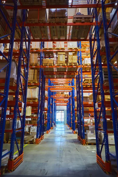 Interior of a modern warehouse storage of retail shop with pallet truck near shelves — Stock Photo, Image